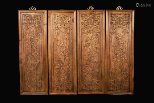 A Set of Four Chinese Camphor Wood Hanging Panels Carved with 