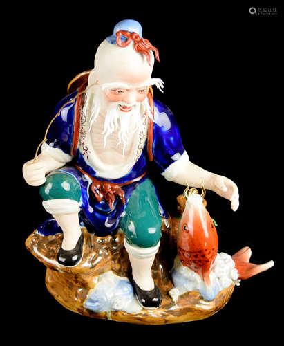 A Porcelain Fisherman Figurine