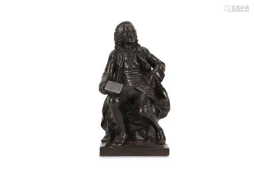 A LATE 18TH / EARLY 19TH CENTURY FRENCH CAST IRON STATUETTE OF VOLTAIRE  depicted seated on a rocky  mound