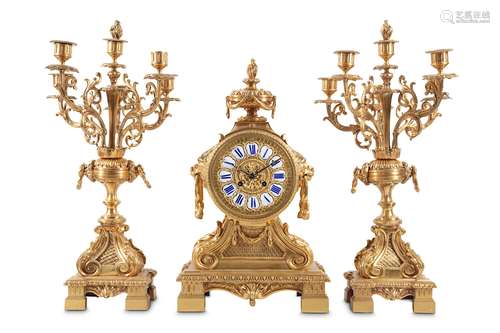 A LOUIS XVI STYLE GILT BRONZE CLOCK GARNITUREthe case of drum form surmounted by a flaming urn and with lion mask handles to the sides