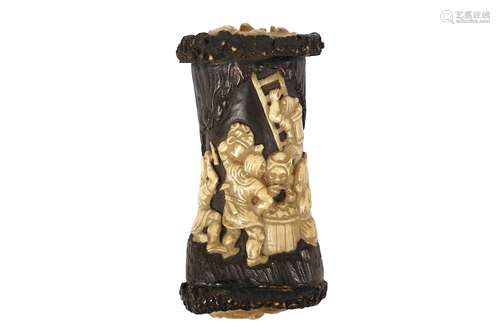 A 19TH CENTURY BLACK FOREST CARVED STAG HORN SNUFF BOXof cylindrical form with oval ends carved with amusing faces with glass eyes