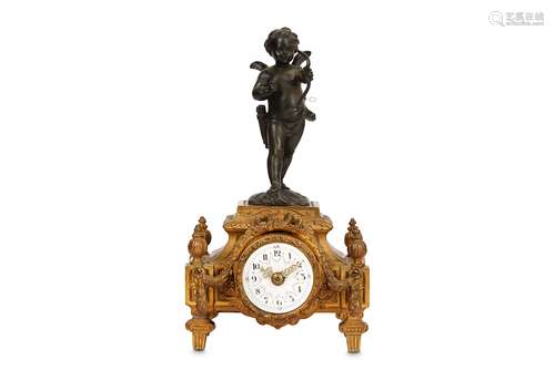 A SMALL LATE 19TH CENTURY FRENCH GILT AND BRONZED METAL MANTEL CLOCK DEPICTING CUPIDcupid with his bow atop the shaped plinth enclosing the enamelled dial with Arabic numerals