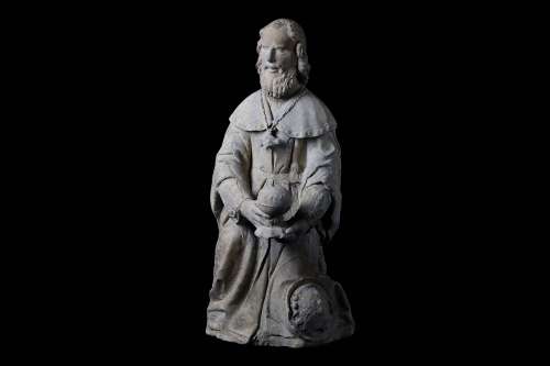 A 15TH CENTURY FRENCH GOTHIC CARVED LIMESTONE FIGURE OF A MAGI KING the kneeling figure holding an orb shaped vessel
