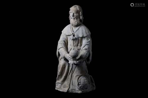 A 15TH CENTURY FRENCH GOTHIC CARVED LIMESTONE FIGURE OF A MAGI KING the kneeling figure holding an orb shaped vessel