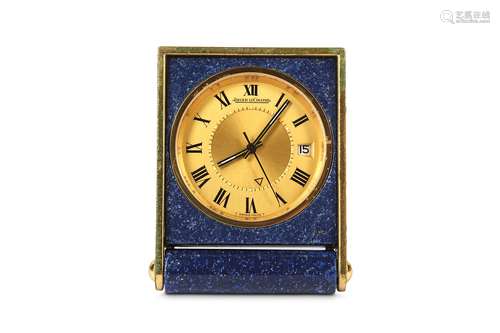 A RARE 1960's / 70's SWISS JAEGER LECOULTRE GILT METAL AND FAUX LAPIS LAZULI MINIATURE TRAVELLING ALARM CLOCK WITH DATE APERTURE AND CENTRE SECONDS MADE FOR CARTIERthe rectangular case with rotating cover that folds back to act as a stand for the clock