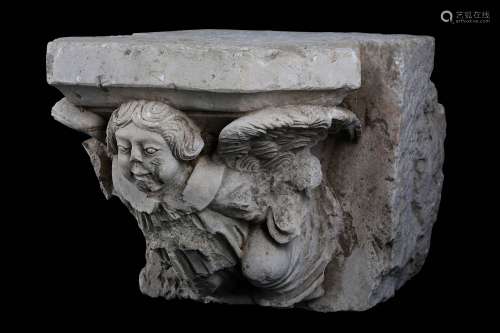 A FRENCH GOTHIC STYLE CARVED LIMESTONE CORBEL DEPICTING AN ANGEL POSSIBLY 16TH CENTURYthe figure with curling hair and outswept wings supporting the shaped shelf above