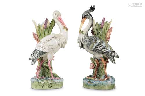 TWO EARLY 20TH CENTURY MAJOLICA POTTERY STICK STANDS MODELLED AS STORKS ATTRIBUTED TO DELPHIN MASSIERone holding a lizard in its beak