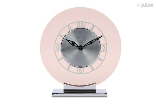 AN ART DECO STYLE JAEGER LECOULTRE PERSPEX AND CHROME DESK CLOCK RETAILED BY GARRARDof circular form with pierced circular chapter ring with Arabic fifteen minute markers