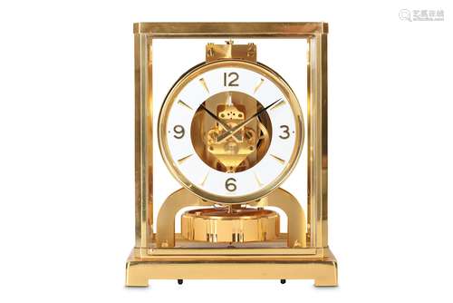 A 1980'S LACQUERED BRASS AND PLEXIGLASS ATMOS CLOCK BY JAEGER LECOULTREthe case with canted corners over a plinth base