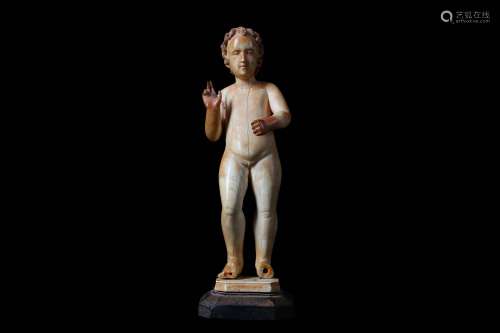 AN 18TH CENTURY SPANISH CARVED IVORY AND PARCEL GILT FIGURE OF THE INFANT CHRIST IN BLESSING the standing figure with right hand raised in blessing