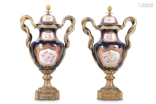 A PAIR OF LOUIS XV STYLE PORCELAIN AND GILT BRONZE MOUNTED VASES AND COVERSin the Sevres style