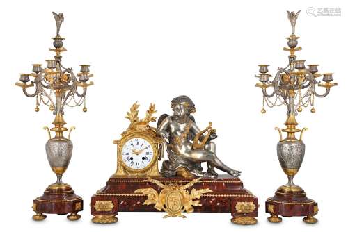 AN EXCEPTIONALLY FINE THIRD QUARTER 19TH CENTURY GILT AND SILVERED BRONZE AND ROUGE MARBLE FIGURAL CLOCK GARNITURE BY CHARPENTIER & CIEthe clock decorated with a figure of Cupid reclining and holding a lyre