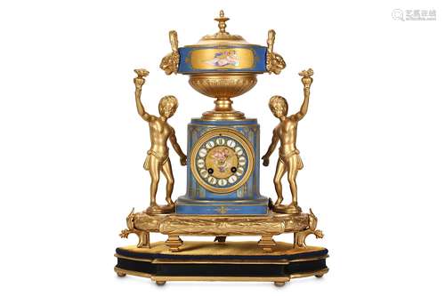 A LATE 19TH CENTURY FRENCH GILT METAL AND PORCLEAIN MANTEL CLOCKthe case modelled as a fluted column surmounted by a twin handled urn and flanked by a pair of figures of children holding flowers