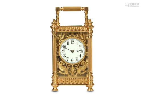 A LATE 19TH CENTURY FRENCH GILT BRASS CARRIAGE CLOCKthe ornate case with ring and knopped finials and feet and three quarter fluted columns to the corners