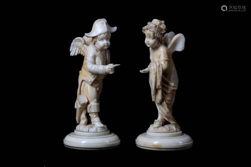 AN UNUSUAL PAIR OF 19TH CENTURY FRENCH (DIEPPE)  IVORY FIGURES OF PUTTI IN NAPOLEONIC DRESS 'THE LOVE LETTER'the male putto amusingly semi-clad in a jacket
