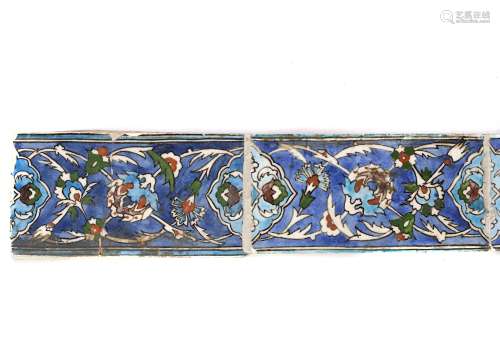 SIX 18TH / 19TH CENTURY IZNIK RECTANGULAR TILESdecorated with scrolling foliage and flowers on a blue ground