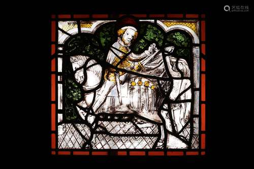 A STAINED AND LEADED GLASS PANEL DEPICTING ST MARTIN OF TOUR