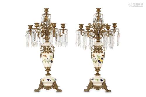 A PAIR OF FIRST HALF 20TH CENTURY CERAMIC AND CUT GLASS CANDELABRAS designed with ceramic baluster supports with trailing flowers on a white ground
