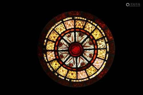 A 19TH CENTURY STAINED AND LEADED GLASS ROUNDELthe circular window with borders of stylised foliage and flowers