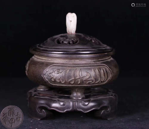 A BRONZE MOLDED TRIPOD CENSER