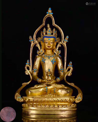 A GILT BRONZE MOLDED BUDDHA STATUE