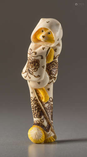 A MAMMOTH IVORY NETSUKE BY DERKACHENKO OF A FOX AS...