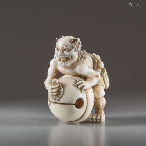 IVORY NETSUKE BY TOMOMASA OF AN ONIIvory netsuk...