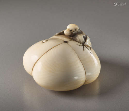 AN IVORY NETSUKE BY SOSAI OF A PERSIMMON AND MONKE...