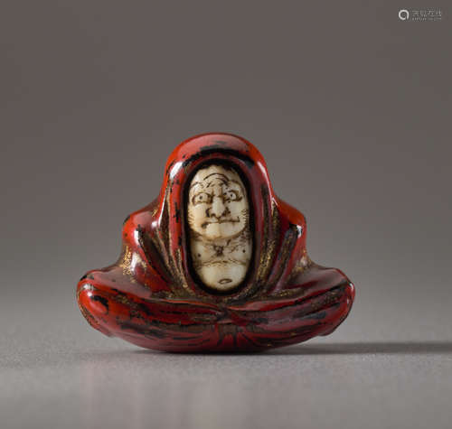 A LACQUERED WOOD AND IVORY NETSUKE OF DARUMAWoo...