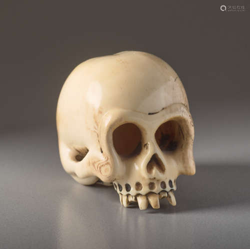 AN IVORY NETSUKE BY SHOZAN OF A SKULLIvory nets...