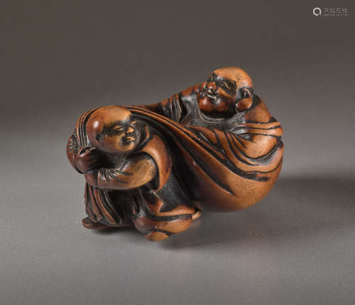 A WOOD NETSUKE OF HOTEIWood netsuke. Japan, 19t...