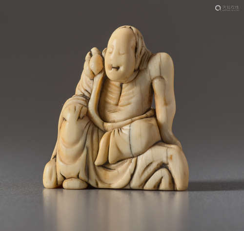 AN IVORY NETSUKE OF AN IMMORTAL ON A ROCKIvory ...