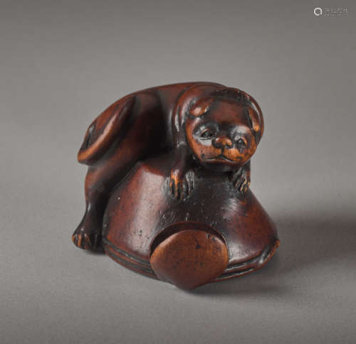 A WOOD NETSUKE OF A DOG AND OCTOPUSWood netsuke...