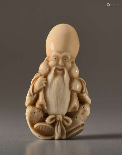 A MAMMOTH IVORY NETSUKE BY DERKACHENKO OF FUKUROKU...