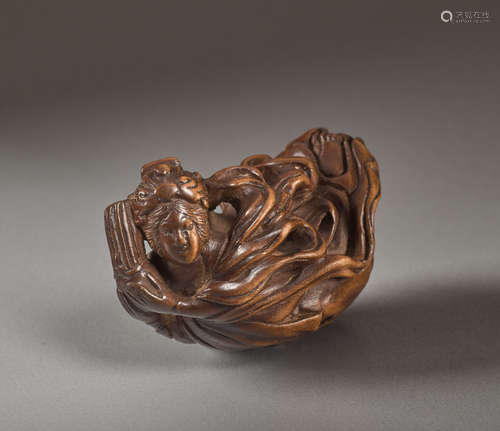 A RARE WOOD NETSUKE OF A FLYING TENNINWood nets...