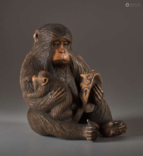 A WOOD OKIMONO BY JIGO OF A MONKEY WITH CHILD AND ...