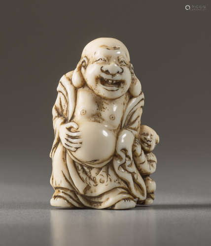 A SMALL IVORY NETSUKE OF HOTEIIvory netsuke. Ja...