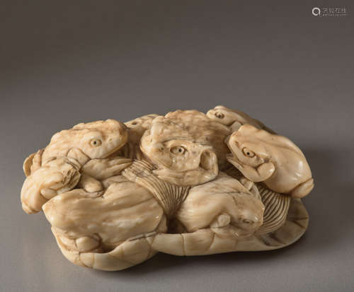 AN IVORY OKIMONO OF TOADS ON A LOTUS LEAFIvory ...