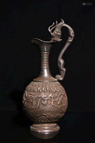 A SILVER CARVED DRAGON EWER