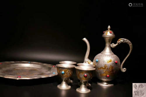 A SET OF SILVER TEAPOT AND CUPS