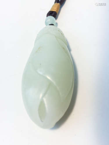 A CELADON JADE CARVED PENDANT