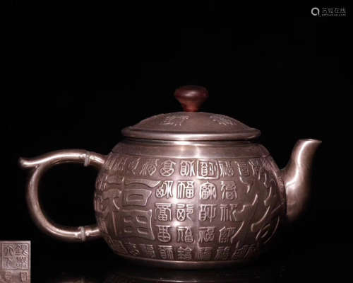A SILVER MOLDED TEAPOT WITH MARK