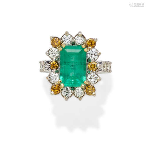 An emerald, colored diamond, diamond and platinum ring