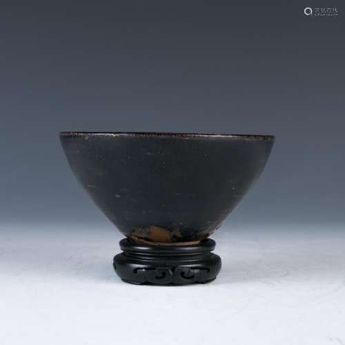 A Small Black Glazed Bowl with a Stand