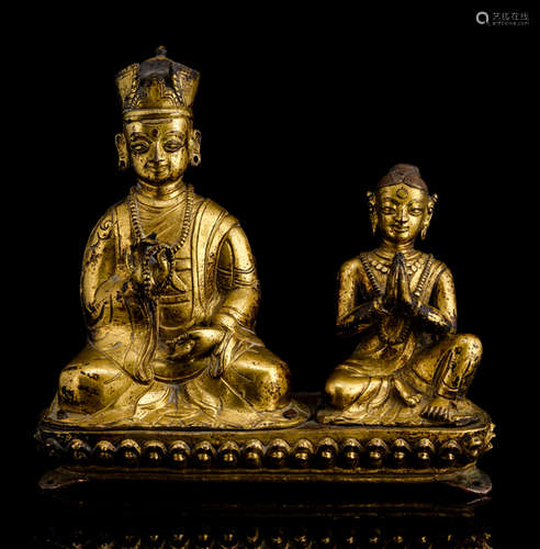 A RARE GILT-BRONZE GROUP OF A KARMAPA LAMA AND A FEMALE DEVOTEE