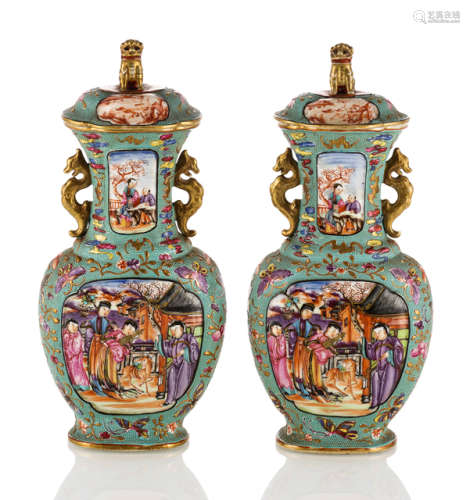A PAIR OF FAMILLE ROSE VASES AND COVERS WITH RELIEF DECOR ON TURQUOISE GROUND