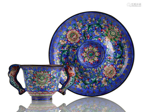 A CANTON ENAMEL HANDLED CUP AND SAUCER WITH FLORAL DECOR