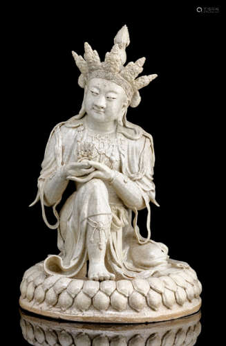 AN UNUSUAL CREAM-CRACKLED GLAZED MODEL OF A SEATED BODHISATTVA ON A LOTOS