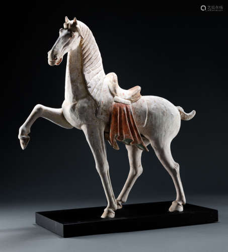 A PAINTED EARTHENWARE MODEL OF A PRANCING HORSE