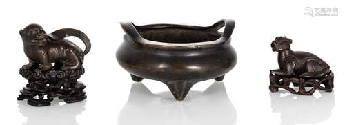 A BRONZE TRIPOD CENSER AND TWO ANIMAL-SHAPED PAPER WEIGHTS